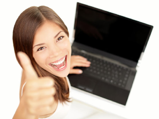 Girl thumbs up while working on laptop