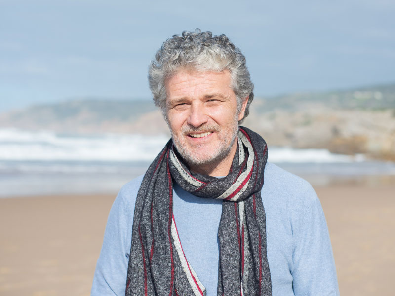 man wearing blue tshirt on beach