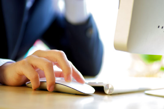 Man using computer and holding the mouse