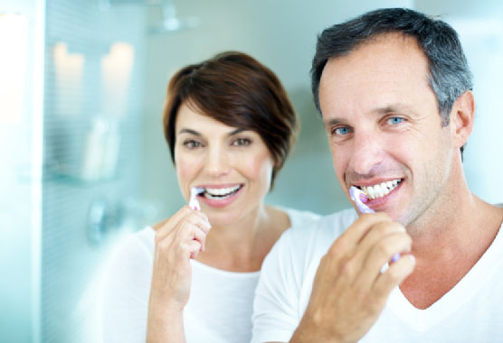 couples brushing there teeth together