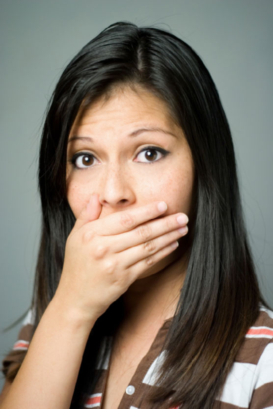 women in shock with face on hand