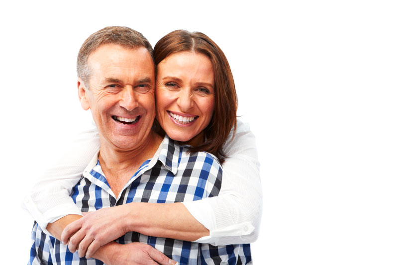 women hugging a man and smiling