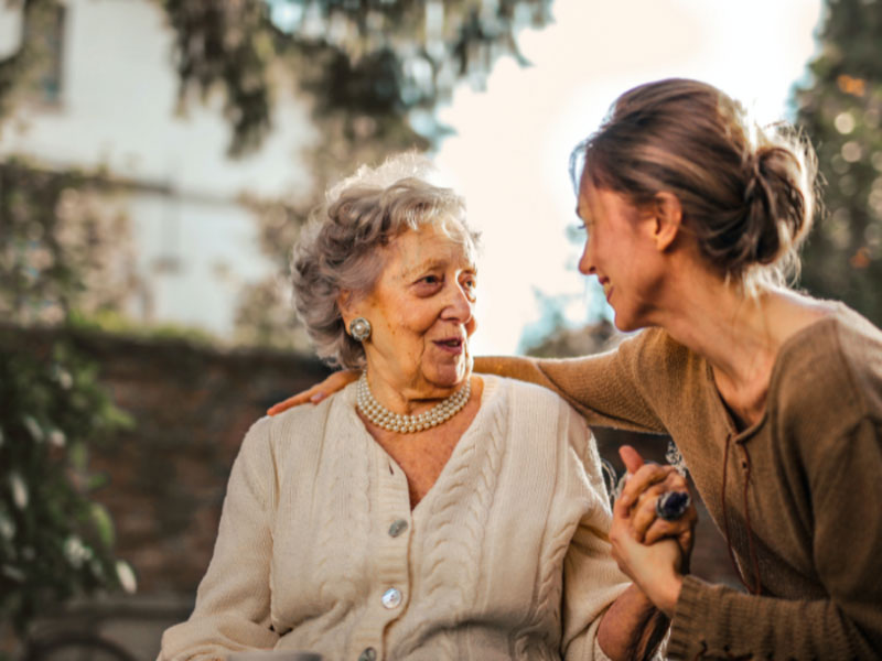 old lady with young girl hold hand