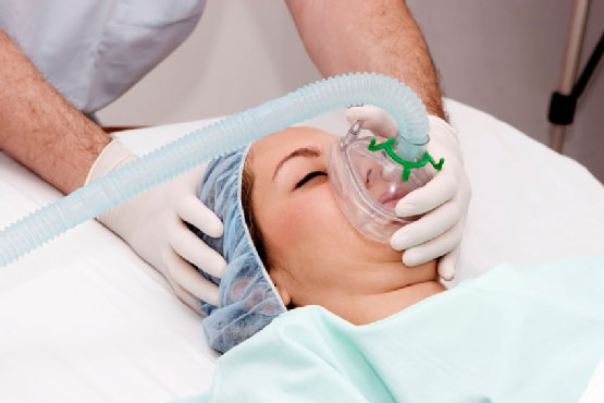 a women in oxygen mask in hospital