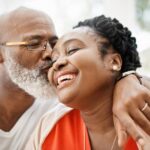 man kissing woman on cheek
