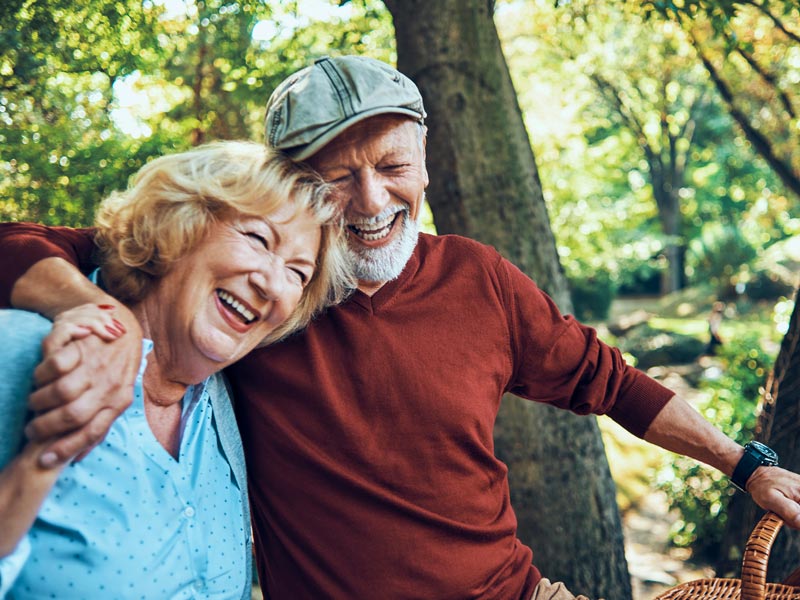 laughing senior couple on picnic