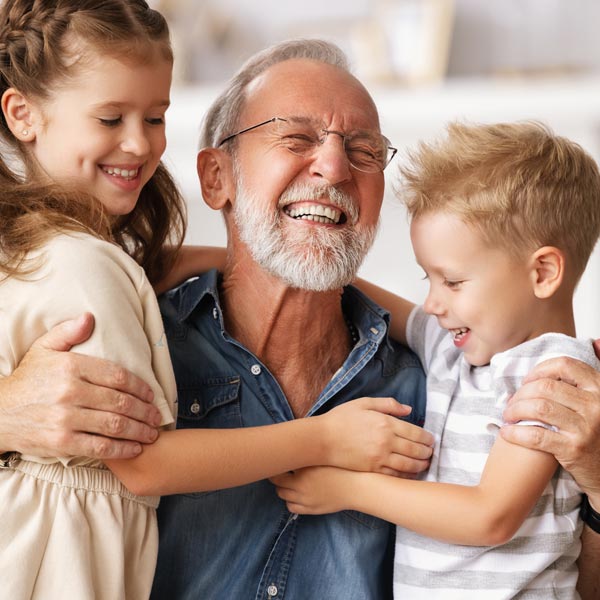 laughing senior man with two grandkids