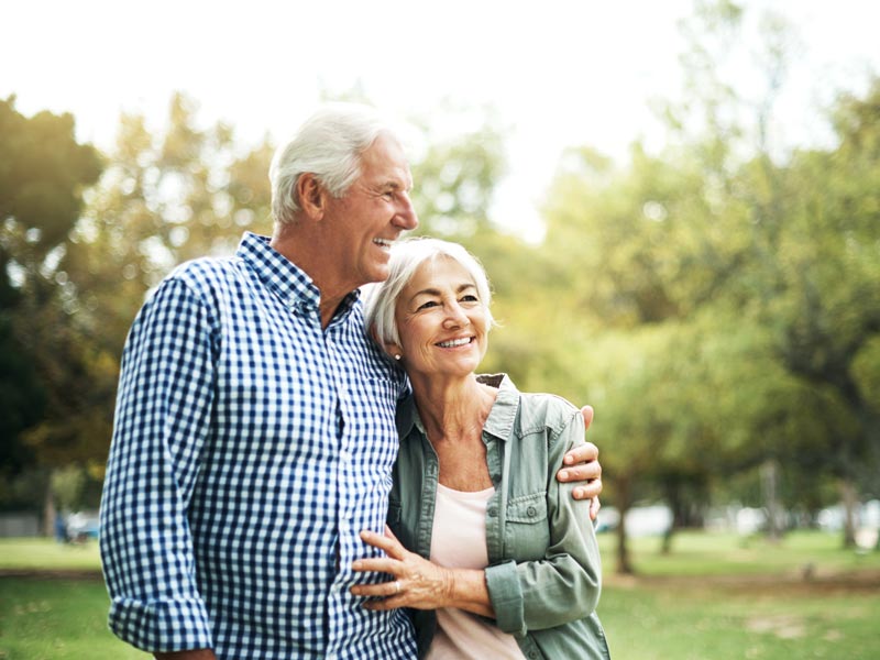 smiling senior couple on walk