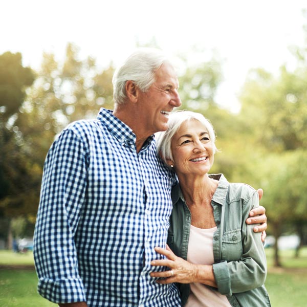 smiling senior couple on walk