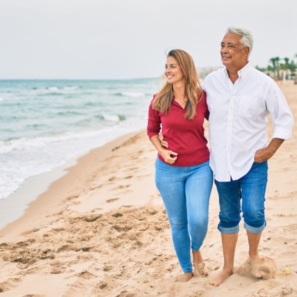 mature couple walking on beach
