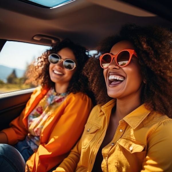 2 women smiling in car